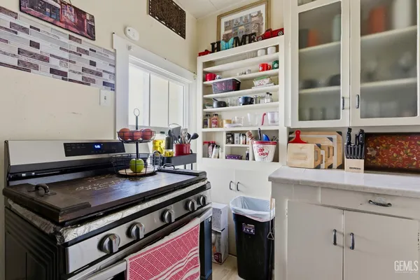 a kitchen with a sink a stove and cabinets