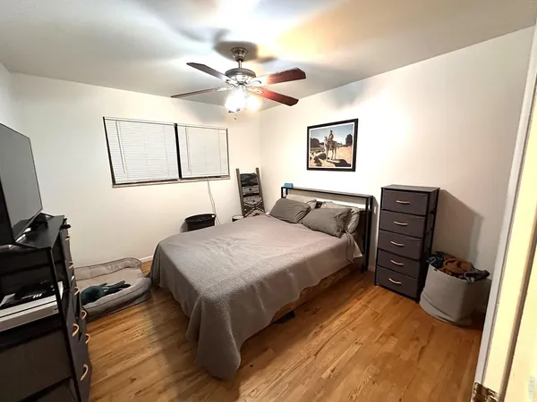 a en suite bathroom with a granite countertop sink and a mirror