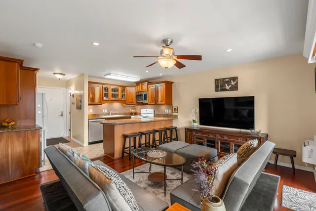 a dining room with furniture and a flat screen tv