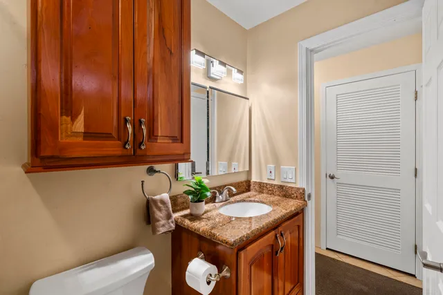 a bathroom with a granite countertop sink and a mirror