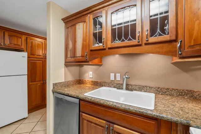 a kitchen with granite countertop a sink and a window