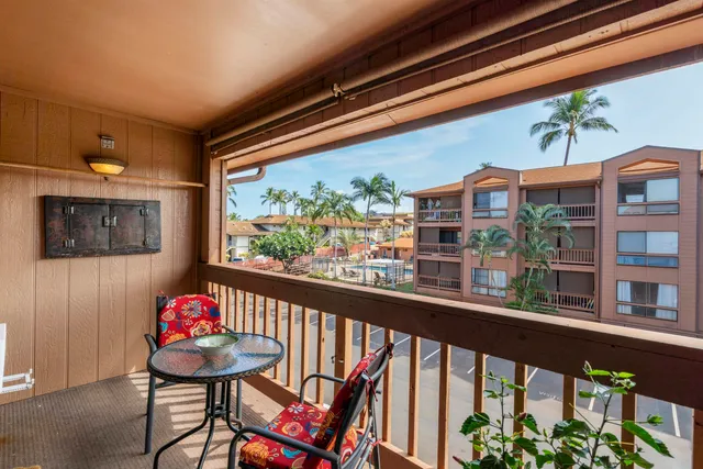 a view of a chairs and table in a balcony