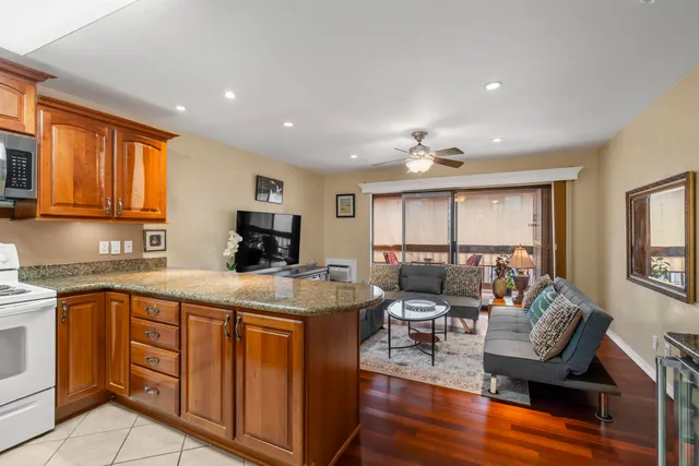 a kitchen with a sink cabinets and wooden floor