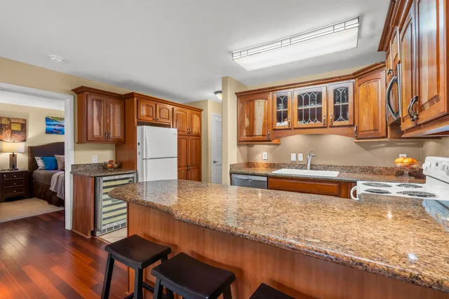 a kitchen with granite countertop a stove and cabinets