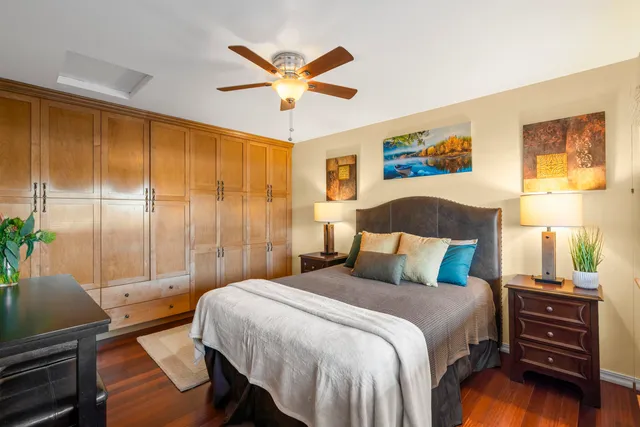 a bedroom with a bed and a chandelier