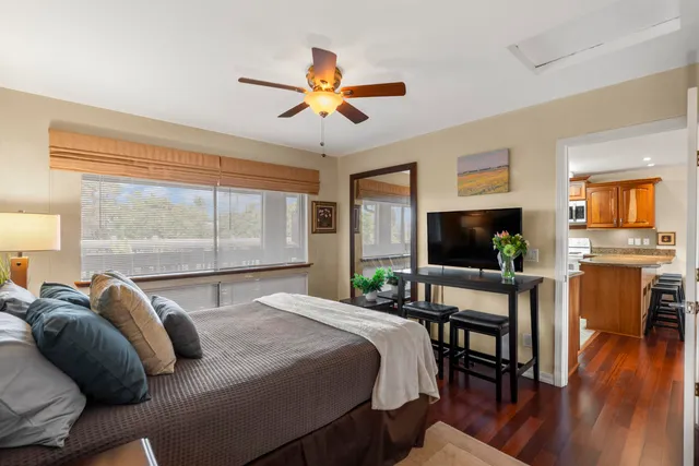 a bedroom with a bed and a flat screen tv