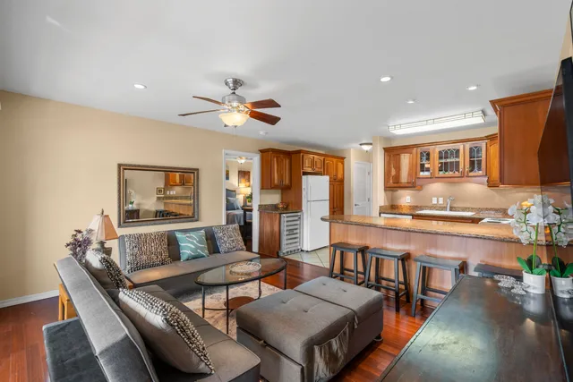 a living room with furniture and a wooden floor
