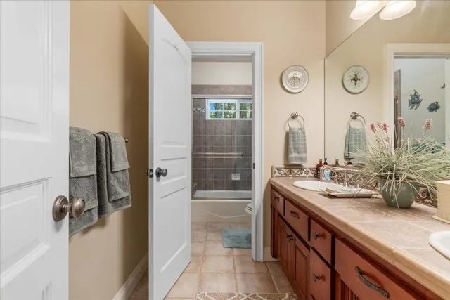 a bedroom with a bed dresser and a fireplace