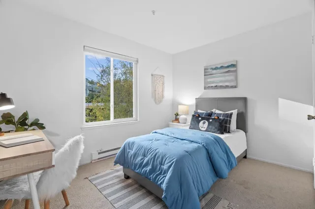 a bedroom with a bed and a window