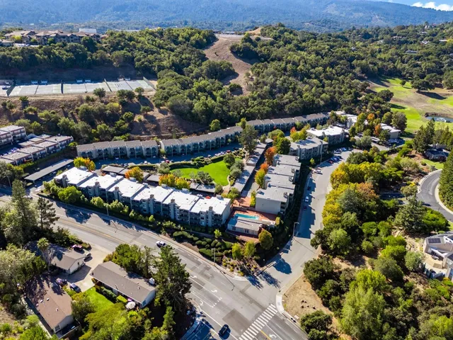 an aerial view of residential houses with outdoor space
