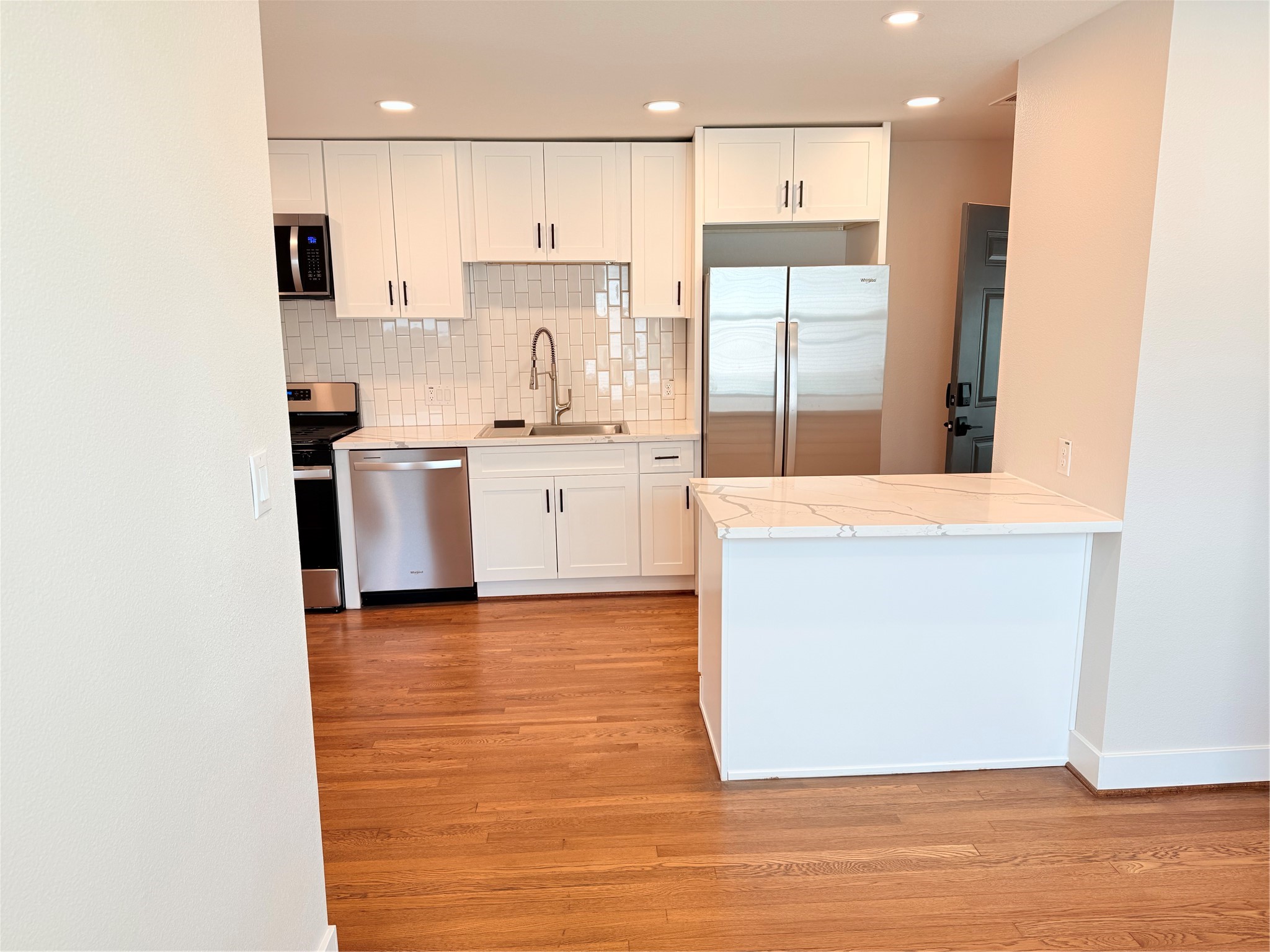 2001 Brun Street, Unit 1 Houston, TX 77019 - Photo 6 of 15 a kitchen with stainless steel appliances granite countertop a stove a sink and a refrigerator