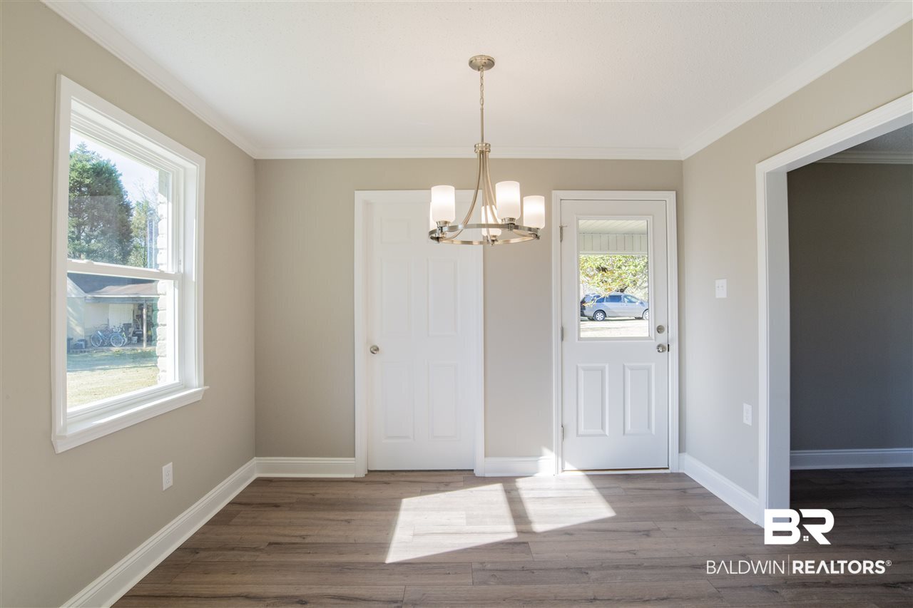 9141 Semmes Court Semmes, AL 36575 - Photo 9 of 28 Designer light fixture and pretty neutral colors.