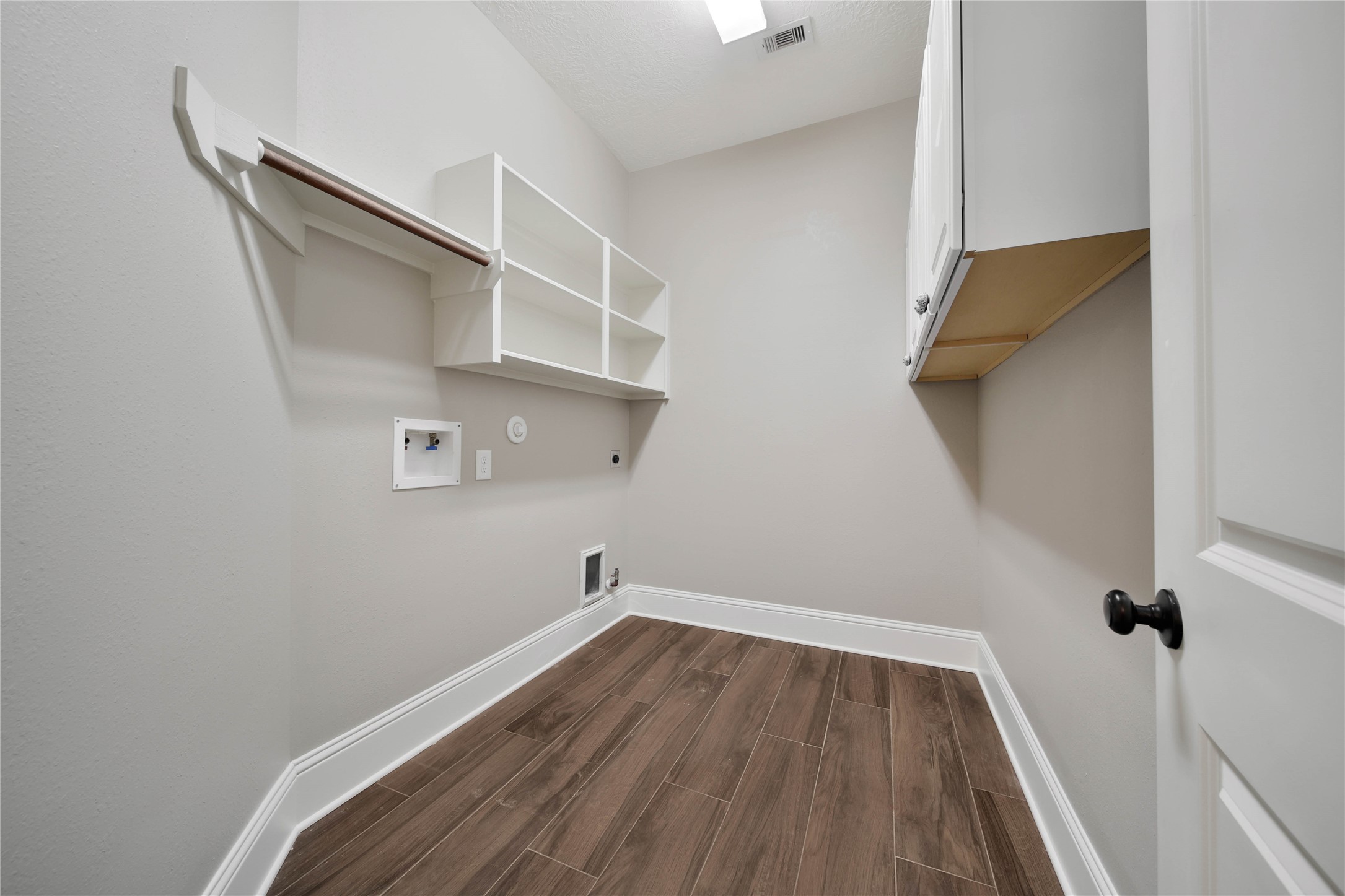 1215 Jake Springs Court Spring, TX 77386 - Photo 31 of 49 The first-floor laundry room offers both gas and electric dryer connections and wonderful storage. Open shelving is ideal for heavily used items while the cabinetry keeps additional clutter tucked away.