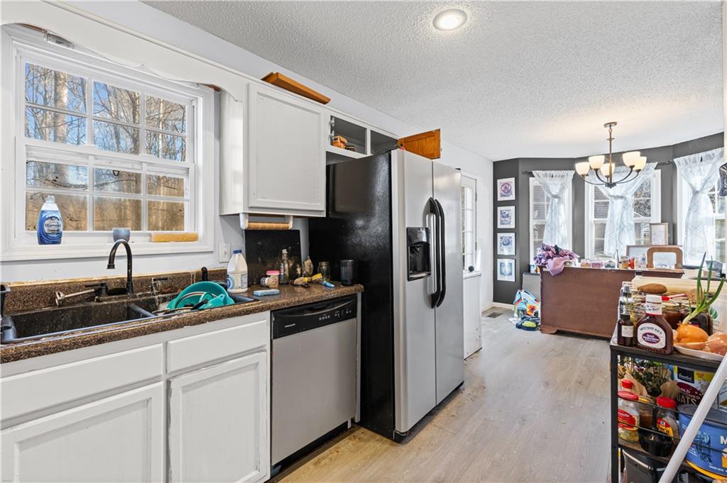 115 Cash Way Rockmart, GA 30153 - Photo 17 of 35 a kitchen with refrigerator a sink and cabinets