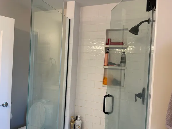 a bathroom with a glass shower door