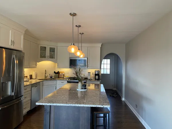 a kitchen with sink a stove and cabinets