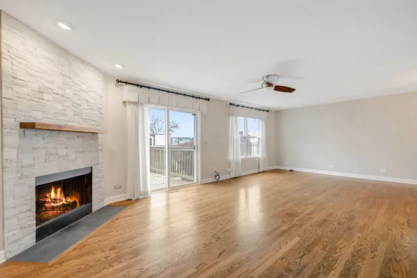 a view of an empty room with a fireplace and a window