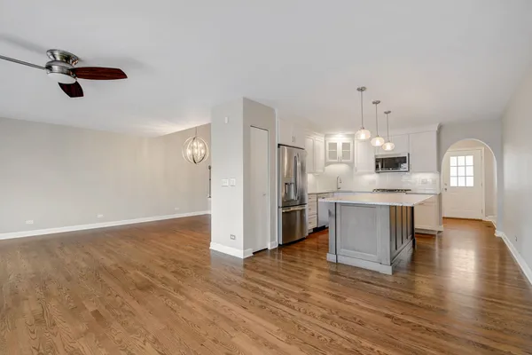 a open kitchen with white cabinets and stainless steel appliances