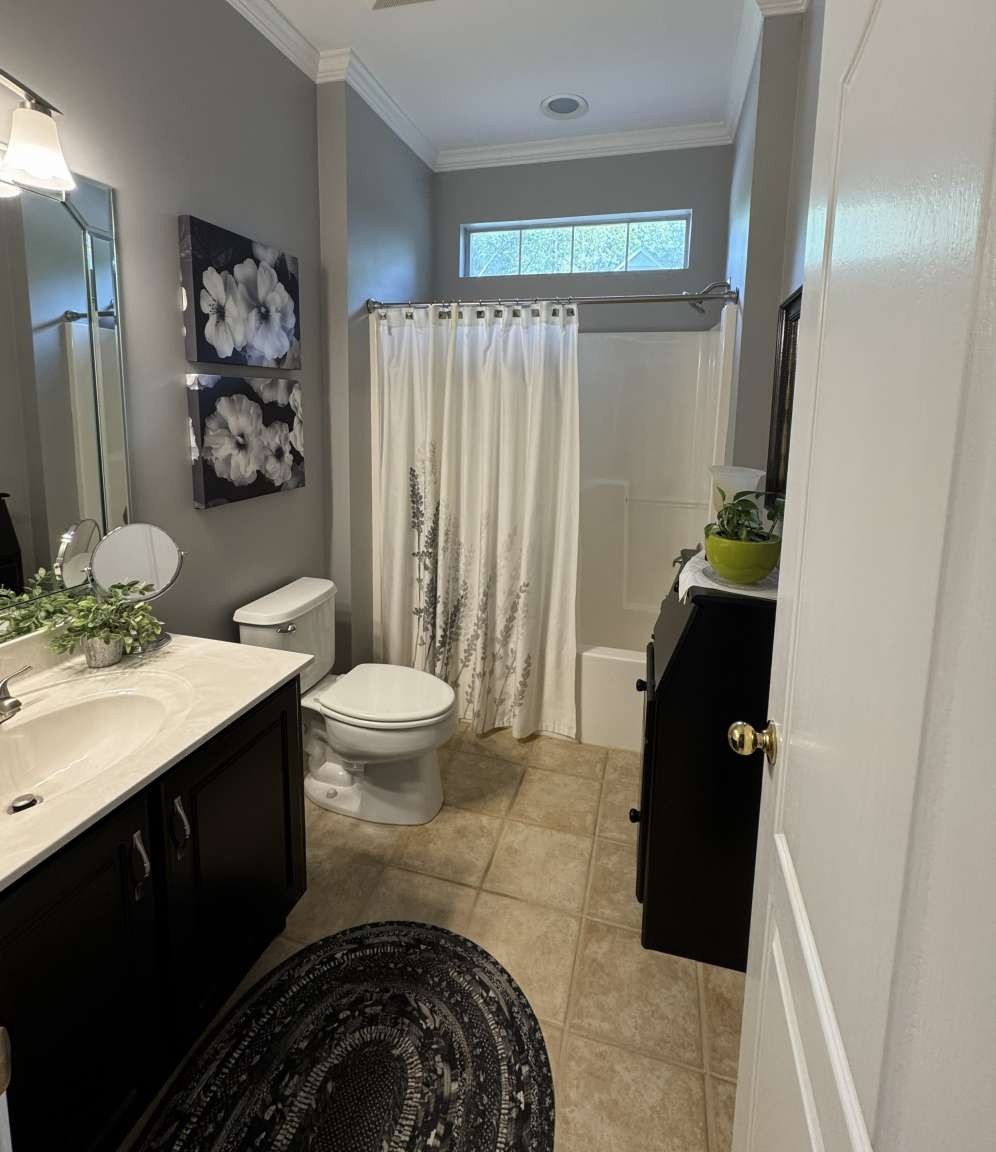 513 Owen Road Leeds, AL 35094 - Photo 17 of 25 a bathroom with a sink a toilet and shower curtain