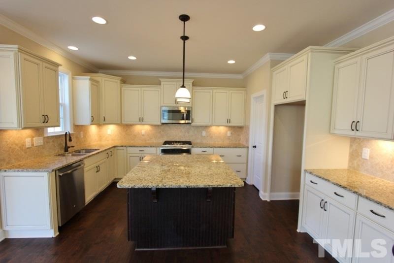 201 Virginia Water Drive Rolesville, NC 27571 - Photo 2 of 25 a large kitchen with stainless steel appliances granite countertop a stove a sink a center island and wooden floor