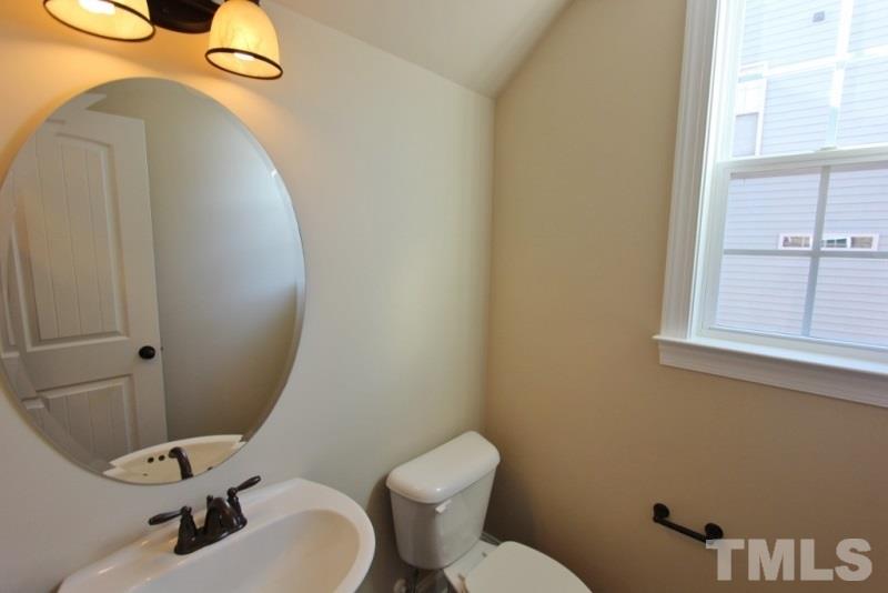 201 Virginia Water Drive Rolesville, NC 27571 - Photo 18 of 25 a bathroom with a toilet sink and mirror