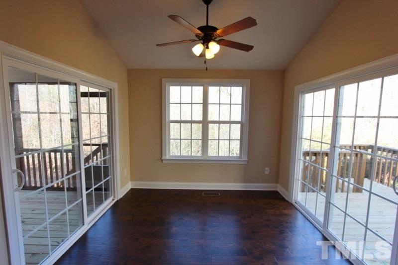 201 Virginia Water Drive Rolesville, NC 27571 - Photo 8 of 25 a view of an empty room with wooden floor and a window