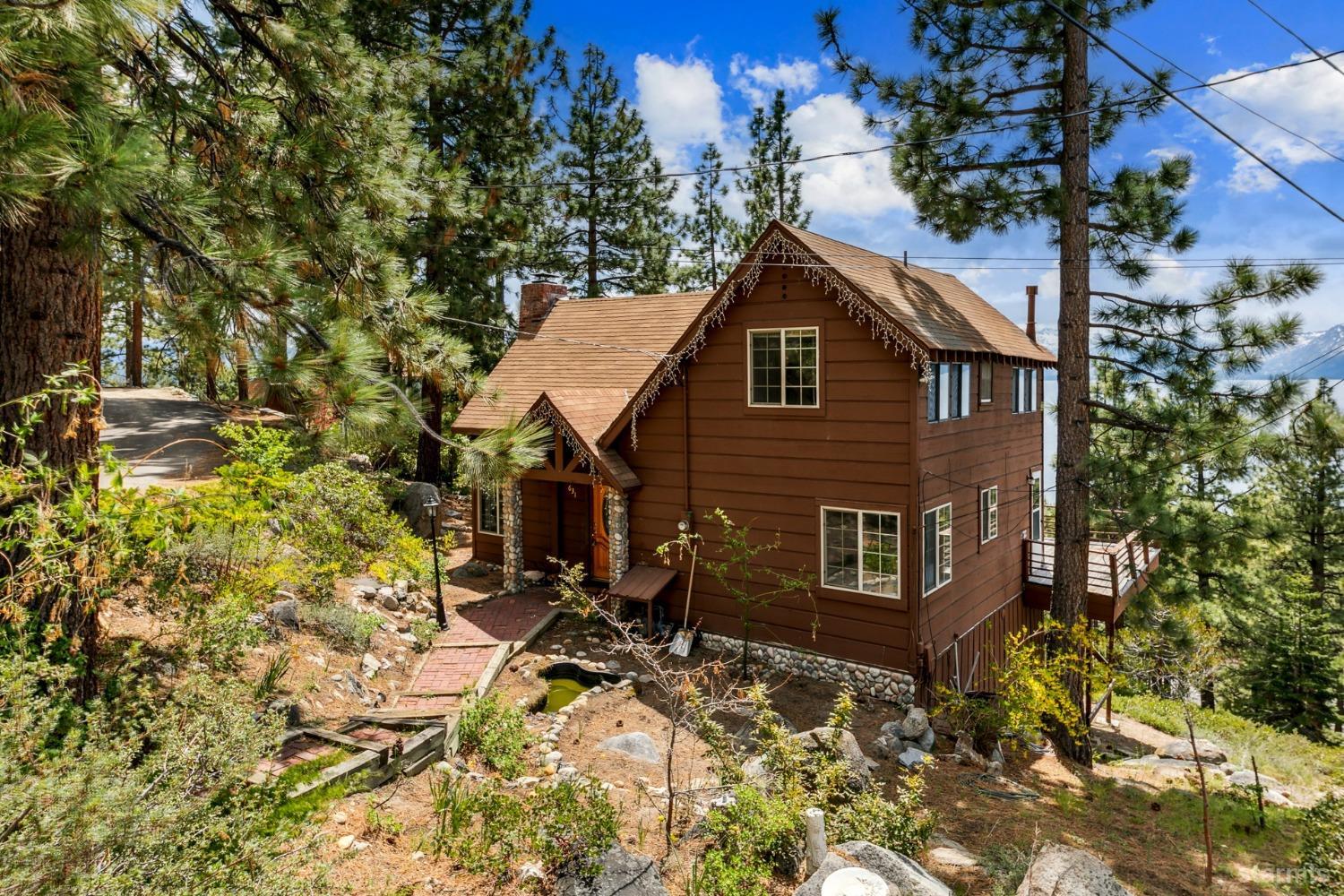 631 Point Road Zephyr Cove, NV 89448 - Photo 2 of 28 a house with trees in front of it