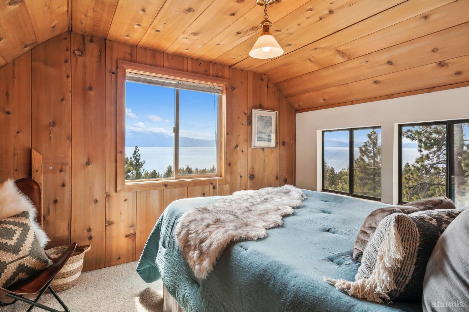 631 Point Road Zephyr Cove, NV 89448 - Photo 23 of 28 a bed sitting in a spacious bedroom next to a window