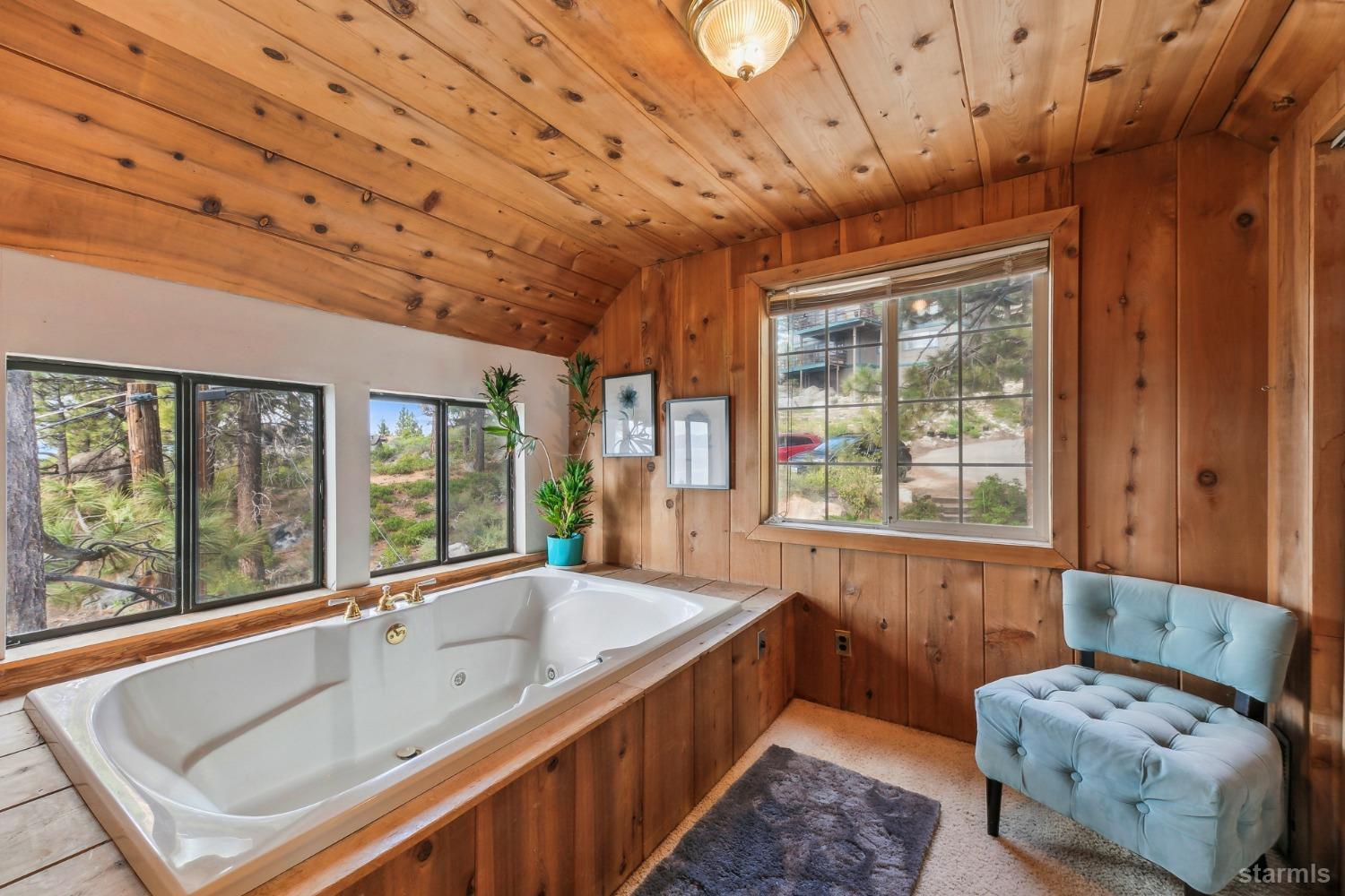 631 Point Road Zephyr Cove, NV 89448 - Photo 24 of 28 a bathroom with a tub sink and window