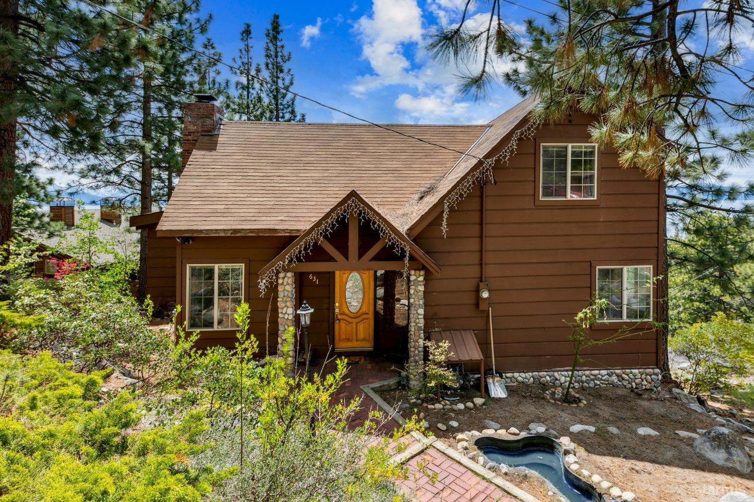 631 Point Road Zephyr Cove, NV 89448 - Photo 3 of 28 a front view of a house with a yard