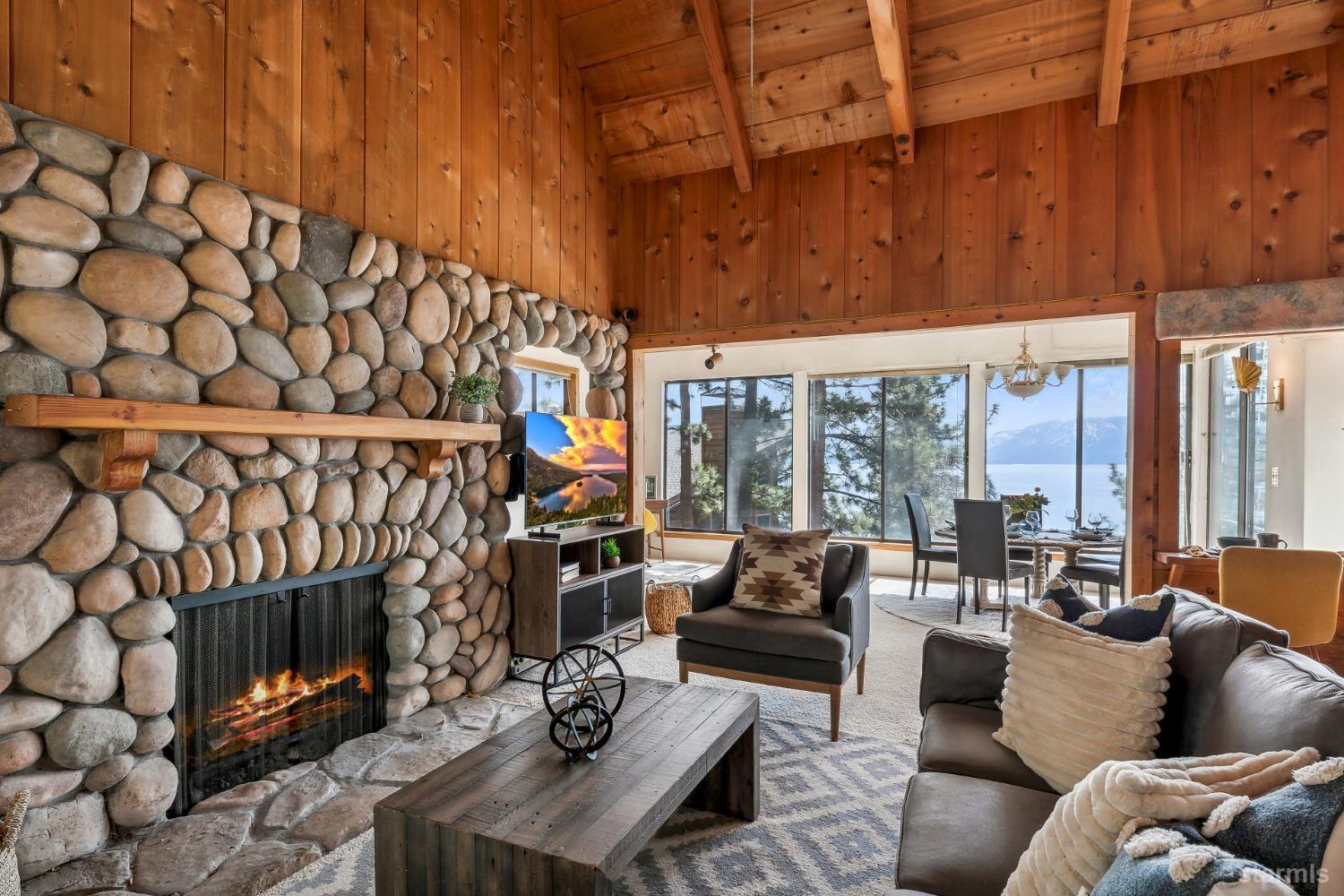 631 Point Road Zephyr Cove, NV 89448 - Photo 5 of 28 a living room with furniture a fireplace and a floor to ceiling window