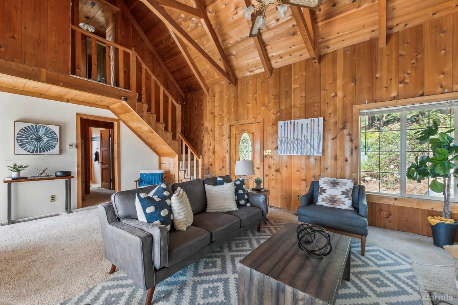 631 Point Road Zephyr Cove, NV 89448 - Photo 7 of 28 a living room with furniture and a large window