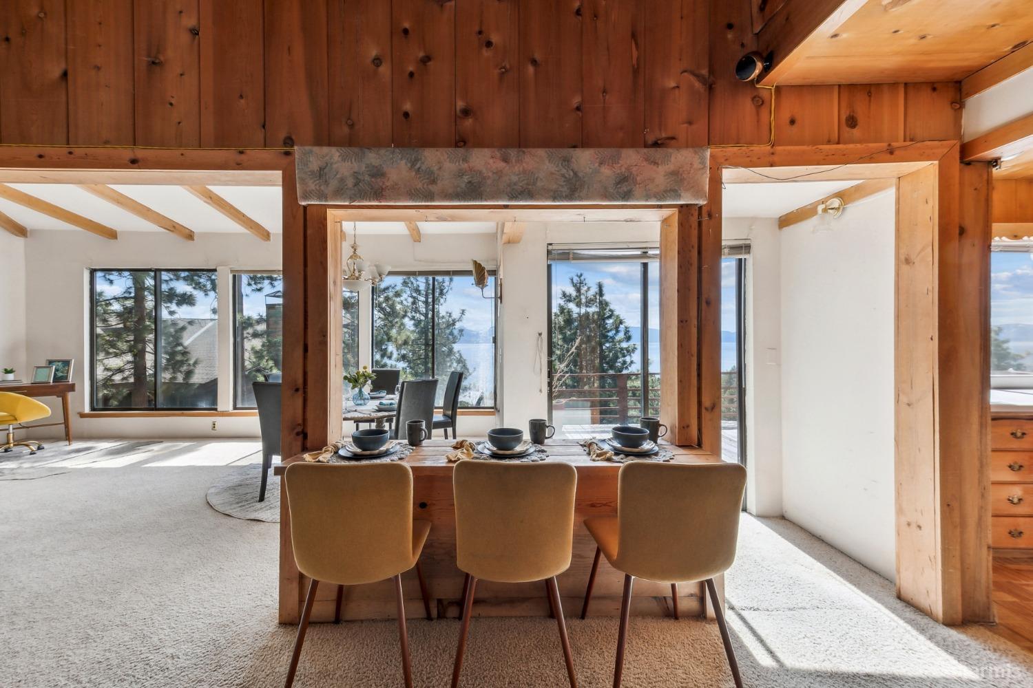 631 Point Road Zephyr Cove, NV 89448 - Photo 8 of 28 a dining table chair with a kitchen island in the center