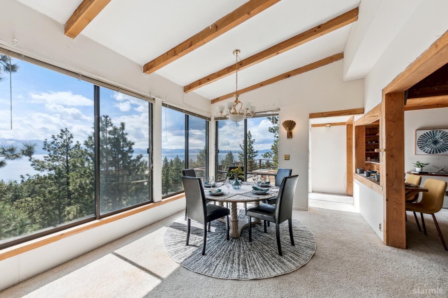 631 Point Road Zephyr Cove, NV 89448 - Photo 9 of 28 a dining room with furniture and a floor to ceiling window