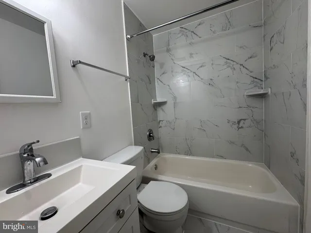a bathroom with a sink a toilet and a bathtub