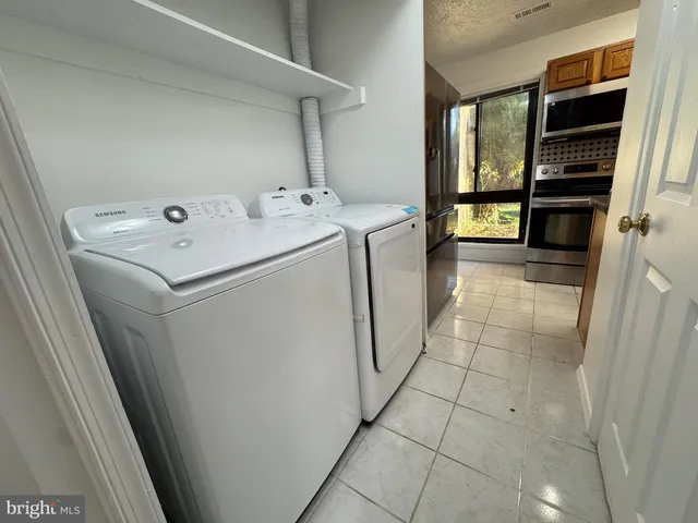 a utility room with dryer and washer