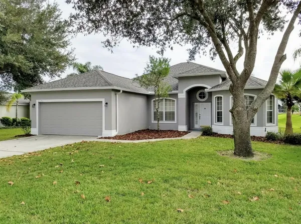 a front view of a house with a garden and yard