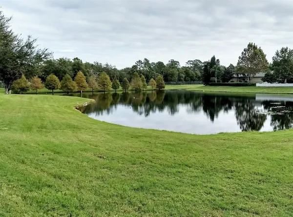 a view of a kitchen with a sink and a refrigerator