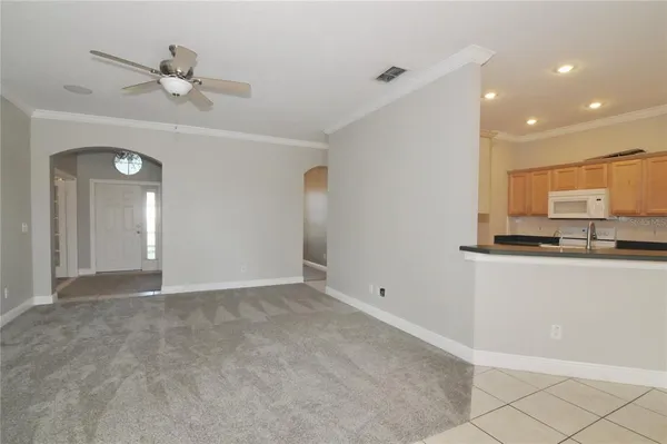 a view of a kitchen with kitchen island granite countertop living room