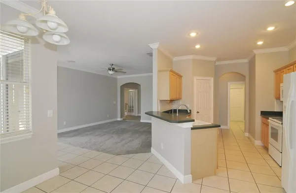 a kitchen with a sink cabinets and a window