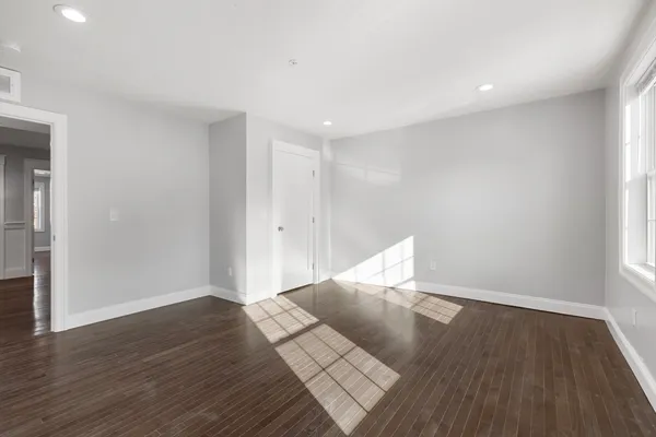 a view of wooden floor and windows in a room