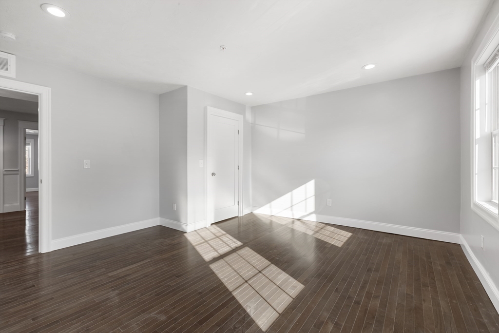 222 Rock Street, Unit 2 Fall River, MA 02720 - Photo 13 of 21 a view of wooden floor and windows in a room
