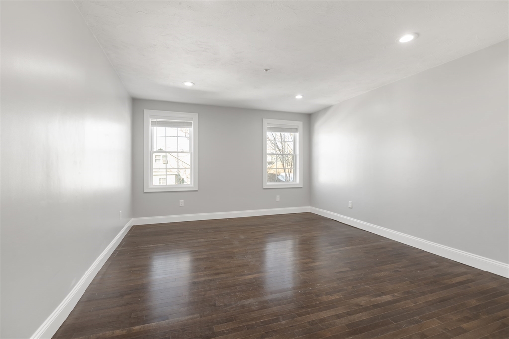 222 Rock Street, Unit 2 Fall River, MA 02720 - Photo 15 of 21 an empty room with wooden floor and windows