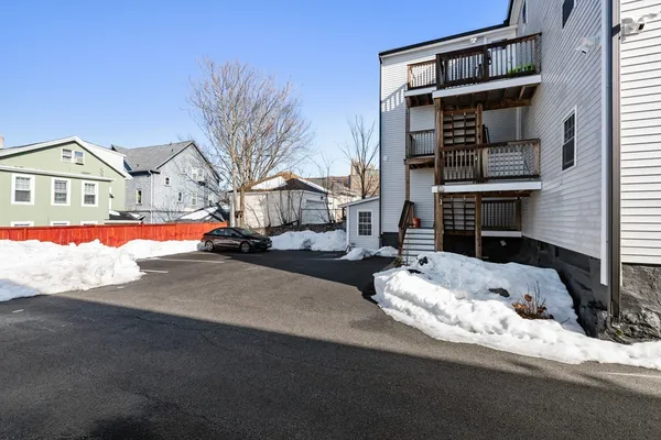a front view of a house with a road