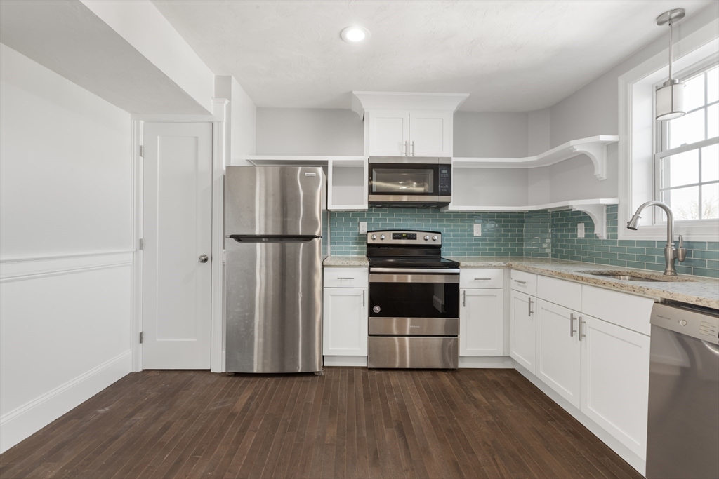 222 Rock Street, Unit 2 Fall River, MA 02720 - Photo 5 of 21 a kitchen with a refrigerator and a stove top oven