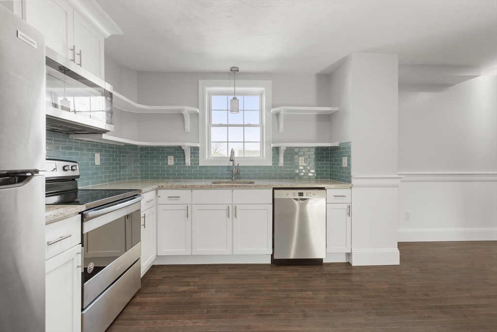 222 Rock Street, Unit 2 Fall River, MA 02720 - Photo 6 of 21 a kitchen with granite countertop white cabinets and white appliances