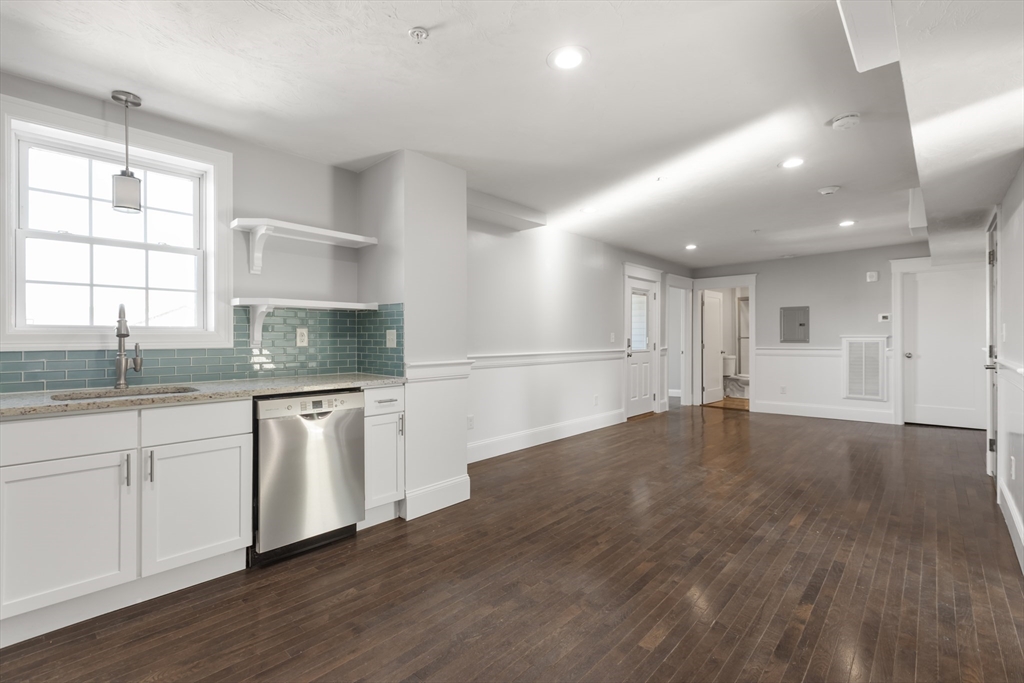 222 Rock Street, Unit 2 Fall River, MA 02720 - Photo 7 of 21 a kitchen with granite countertop a stove a sink and a refrigerator