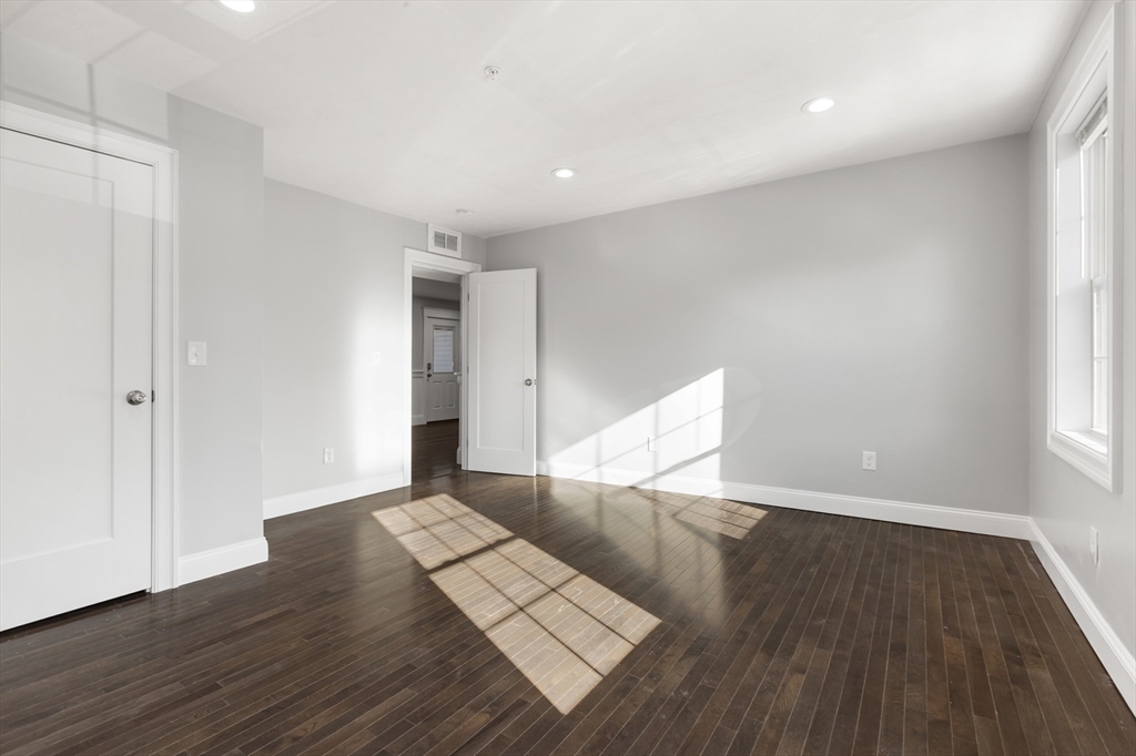 222 Rock Street, Unit 2 Fall River, MA 02720 - Photo 9 of 21 a view of an empty room with wooden floor