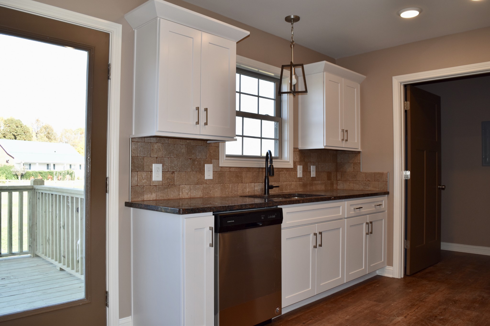 151 East Carter Road Portland, TN 37148 - Photo 5 of 14 a kitchen with granite countertop white cabinets and a window