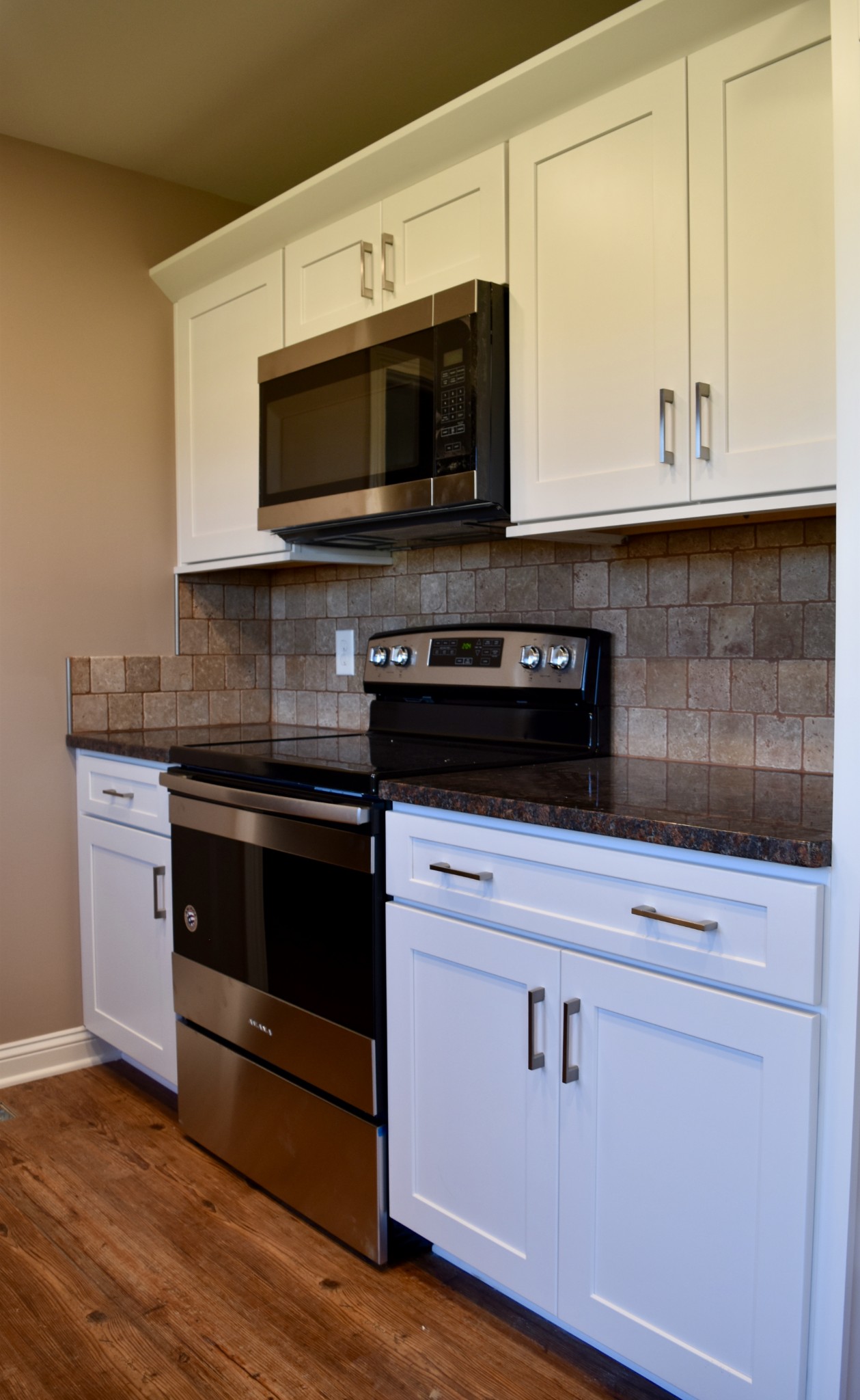 151 East Carter Road Portland, TN 37148 - Photo 6 of 14 a kitchen with stainless steel appliances granite countertop a stove microwave and oven